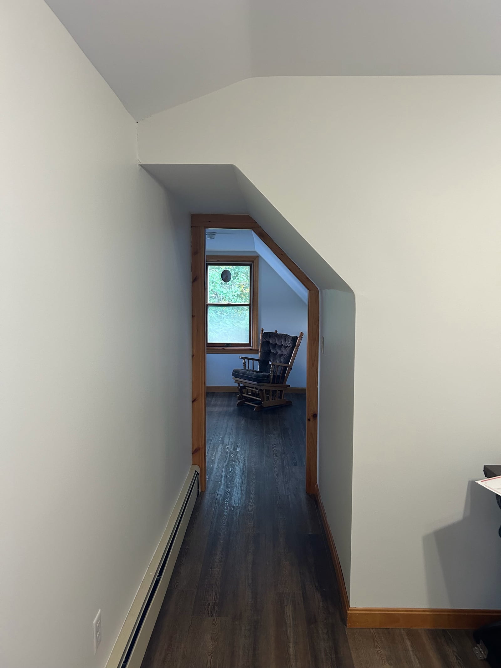 Painted hallway leading to a bedroom nook