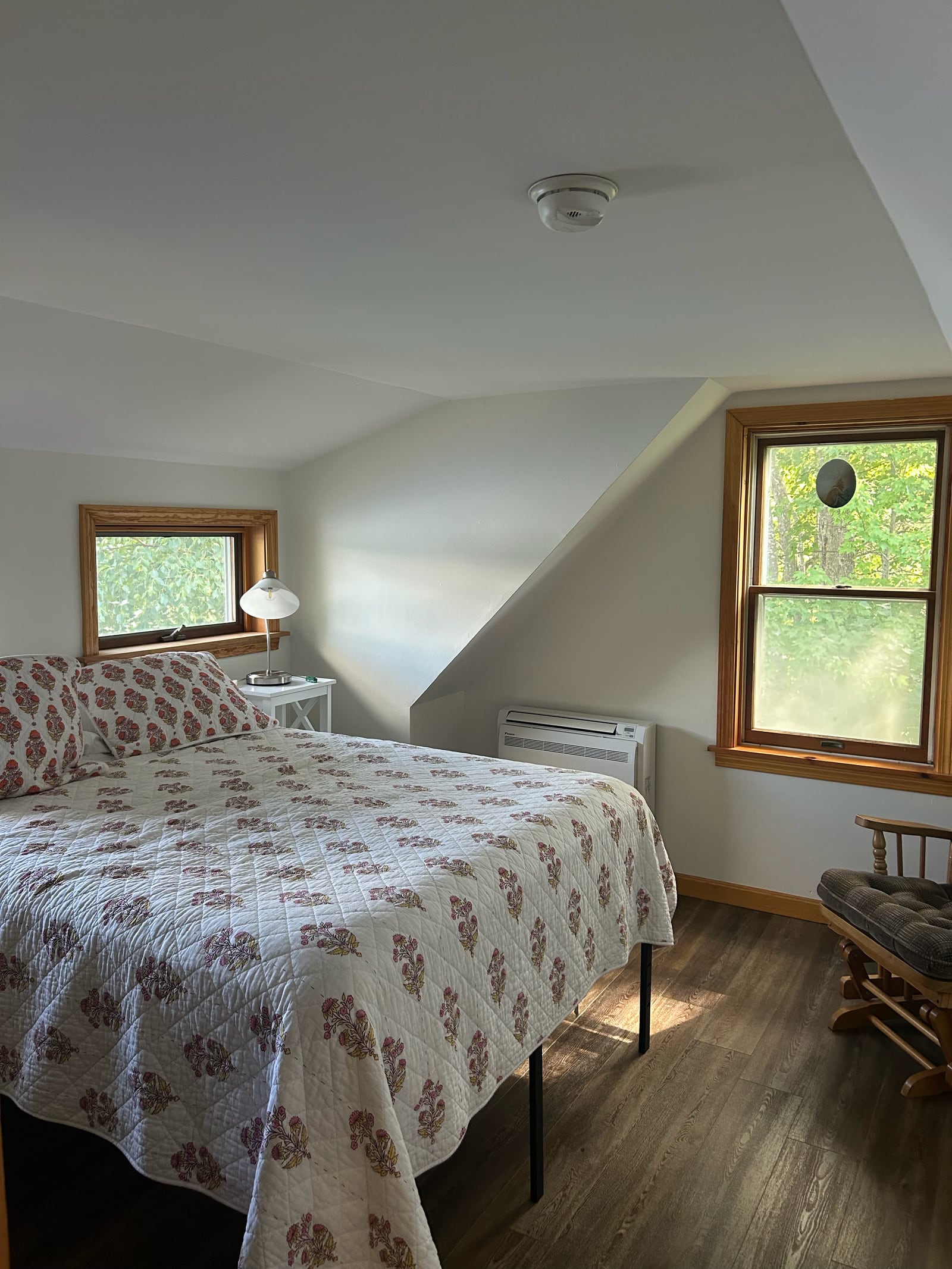 Bedroom with light walls and a sloped ceiling